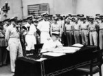 Admiral Sir Bruce Fraser signing the surrender instrument on behalf of the United Kingdom aboard USS Missouri, Tokyo Bay, Japan, 2 Sep 1945, photo 1 of 3