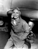 Betty Gillies posing besides an aircraft, date unknown