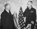 US Navy Captain James Doyle (right) presenting US Secretary of the Navy Frank Knox (left) the first US flag over Japanese-held territory (Kwajalein), Washington DC, United States, 29 Feb 1944