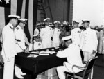 Japanese 4th Fleet commander Vice Admiral Chuichi Hara signing the surrender ceremony aboard USS Portland, Truk, Caroline Islands, 2 Sep 1945; note US officers, left to right, Lieutenant S. E. Thompson, Captain O. F. Naquin, Vice Admiral George Murray, Captain D. N. Cone, Captain L. A. Thackrey, Lieutenant L. L. Thompson, and Lieutenant A. M. Soden