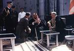 Franklin Roosevelt and King Abdul-Aziz (Ibn Saud) of Saudi Arabia aboard USS Quincy, Great Bitter Lake, Egypt, 14 Feb 1945. The King is speaking to the interpreter, Marine Corps Colonel William A. Eddy (kneeling), minister to Saudi Arabia