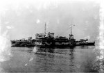 Broadside view of Biscayne in her original configuration with a large crane and clear fantail, Boston Navy Yard, Massachusetts, United States, 19 Jan 1942; note OS2U Kingfisher aircraft on tail