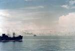 USS President Jackson (foreground) and HMAS Australia (background) maneuvering between Tulagi and Guadalcanal, 8 Aug 1942; photograph taken by personnel aboard USS Ellet