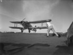 Flight deck signal officer directing the landing of an Albacore aircraft of No. 820 Squadron FAA aboard HMS Formidable, 1940s