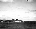 Japanese pilot Shigeyuki Sato in a D3A dive bomber plunging toward USS Hornet during Battle of the Santa Cruz Islands, 26 Oct 1942; note B5N torpedo bomber in level flight and splash from anti-aircraft shell burst in front of Hornet