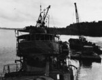 Kikuzuki under salvage, Ghovana Bay, Florida Islands, 10 Aug 1943, photo 1 of 2; note barge with crane on the right side of the photograph and USS Menominee aft of Kikuzuki