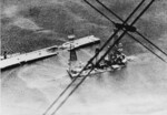 Sunken battleship Kilkis at the Salamis Naval Base, Greece, late Apr 1941; note bomb-damaged pier; photographed from a German He 60 seaplane after the Germans had secured the naval base