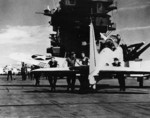 Flight deck crew pushing a SBD-2 Dauntless aircraft into position aboard USS Lexington, 1941