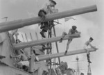 Sailors of HMS Mauritius cleaning barrels of 6-inch guns, date unknown