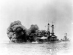 USS Oklahoma firing her 14-inch guns during exercises in the 1920s; note USS Nevada astern