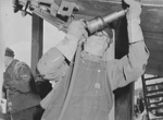 Shipyard caulker/chipper working on a submarine, possibly the future USS Puffer, at Manitowoc, Wisconsin, United States, Aug 1942