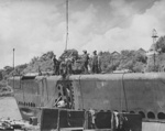 Shipyard workers installing engine parts onto a submarine, possibly the future USS Puffer, at Manitowoc, Wisconsin, United States, Aug 1942, photo 2 of 2