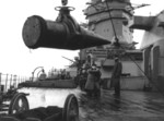 Sailors aboard HMS Rodney receiving a 16-inch shell from an ammunition ship, 1940, photo 2 of 2