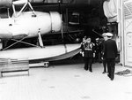 San Francisco in a South American port, with US Navy Rear Admiral Husband E. Kimmel and a South American officer onboard for tours, 1939; note SOC-1 aircraft in hangar