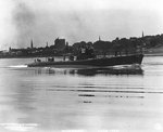 Skipjack running up Thames River after departing the Electric Boat Company shipyard at Groton, Connecticut, United States to go to the Naval Submarine Base for commissioning ceremonies, 30 Jun 1938