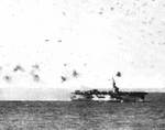 USS Steamer Bay under attack near the Philippine Islands, 5 Jan 1945; note special attack aircraft flying past her stern