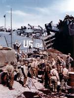 US Army CCKW 2 1/2-ton 6x6 cargo truck with Browning M2 machine gun preparing to be loaded aboard an LST prior to the Normandy invasion, southern England, Jun 1944, photo 1 of 2