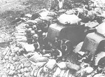 Japanese Navy Shanghai Special Naval Landing Force personnel fighting from a sandbagged position in Shanghai, China, supported by dug-in Crossley armored cars, 1930s