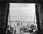 Jeep bringing casualties to a LST for evacuation, Utah Beach, Normandy, France, 13 Jun 1944; note line of German POWs