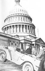 US Senators William Meade (NY) and Elbert Thomas (UT) riding a Willys Quad as it climbed steps in front of the US Congress building, Washington, DC, United States, seen in 20 Feb 1941 issue of the Washington Daily News