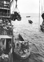 M2A4 Stuart tank being hoisted from USS Alchiba into a LCM(2) landing craft, off Guadalcanal, Solomon Islands, 7 Aug 1942