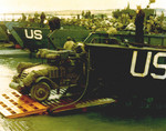 A US Army half-track antiaircraft machine gun vehicle backed into the well deck of a US Navy LCT in preparation for the Normandy invasion, late May or early Jun 1944. Photo 2 of 2