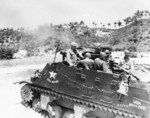 M7 self-propelled artillery vehicle of B Battery, 300th Armored Field Artillery Battalion, US X Corps firing shells at North Korean defensive lines, 1 Jul 1951