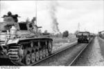 Panzer III tank and SdKfz. 251 halftrack vehicle near Aiviekste, Latvia, Jun 1941; note rangefinder on the halftrack