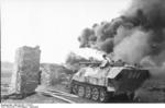 German SdKfz. 251/16 No. 644 halftrack vehicle torching a building with a flamethrower, Russia, Aug 1944, photo 3 of 3