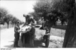 German troops transporting a wounded soldier with a SdKfz. 251 halftrack vehicle, Eastern Front, 21 Jun 1944, photo 2 of 2