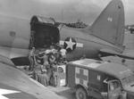 A Marine on Saipan was transferred to an R5C-1 Commando aircraft from a Dodge WC54 3/4-ton field ambulance for transfer to Hawaii, 1944; note the Jeep in between