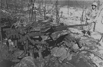 US Marine walking by a Japanese Type 96 25mm anti-aircraft gun on Tinian, Mariana Islands, Jul-Aug 1944