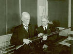 John M. Browning and Mr. Burton studying a BAR at the Winchester Repeating Arms Company plant, Connecticut, United States, circa 1918