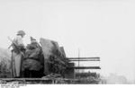 German Flakvierling 38 anti-aircraft gun in Warsaw, Poland during the uprising, Aug 1944; note MP 40 submachine gun