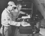 Americans at work at a base on Saipan, Mariana Islands, 1945; note M3 Fighting Knife on the non-commissioned officer