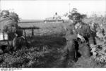 German MG42 machine gun crew in France, Jun 1944; note captured French S35 tank in background