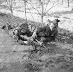 Men of D Company, 1st Battalion, British London Irish Rifles regiment preparing to fire a PIAT launcher during a training exercise, Forlì, Italy, 1 Feb 1945