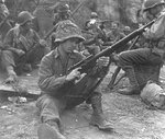 US Army Pfc. Edward J. Foley of the 143rd Infantry Regiment of the 36th Division cleaning his Springfield M1903A4 sniper rifle, near Valletri, Italy, 29 May 1944