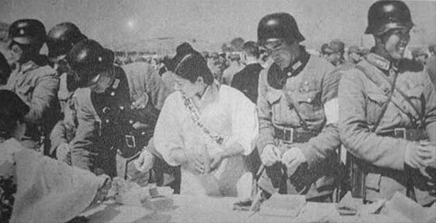 Chinese soldiers of the Japanese-sponsored Nanjing puppet government with a Japanese woman, China, date unknown