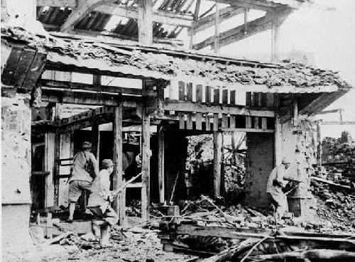 Chinese troops fighting in the ruins of a town, China, 1930s-1940s