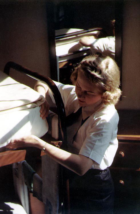 WAVES trainee tucking in her bedding at in her quarters at a Naval Training Center in the United States, circa 1943-1945