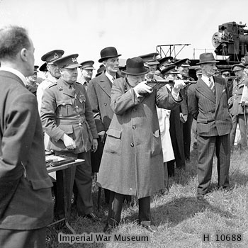 Winston Churchill took aim with a Sten gun during a visit to the Royal Artillery experimental station at Shoeburyness in Essex, England, United Kingdom, 13 Jun 1941