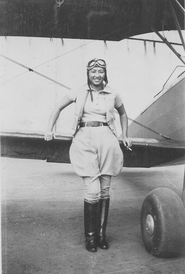 Hazel Lee posing with a biplane, United States, circa 1930s