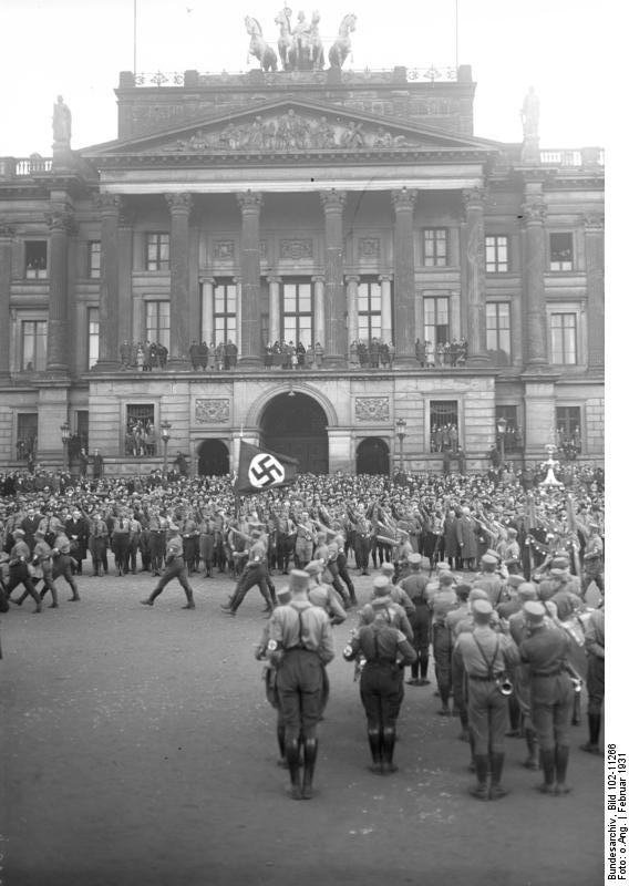 Adolf Hitler reviewing a Nazi Party rally, Braunschweig, Germany, Feb 1931, photo 1 of 2