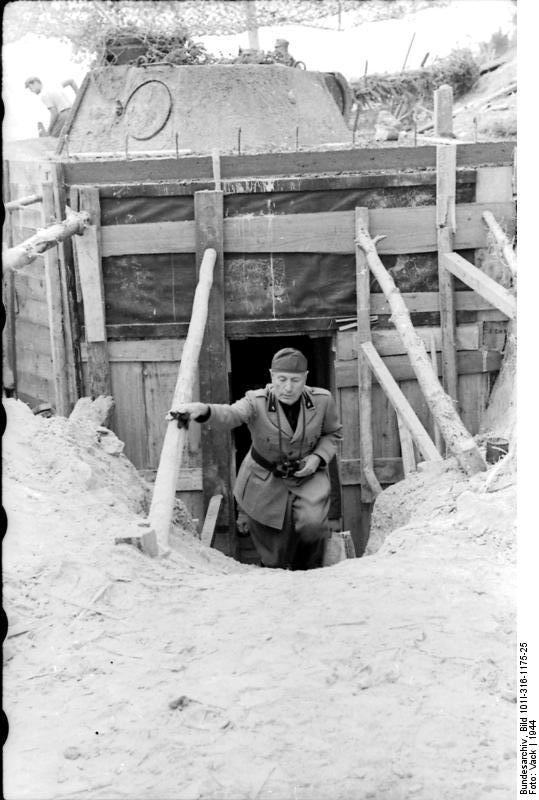 Benito Mussolini inspecting a defensive fortification, Italy, 1944; note the Panzer V turret