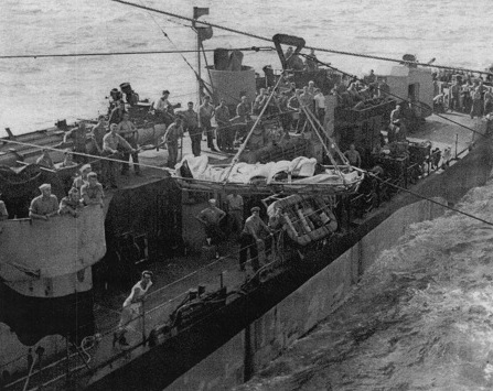 Appendicitis patient Seaman 1st Class J. R. Morris being transported from destroyer USS Grady to carrier USS Anzio for treatment, Pacific Ocean, 24 Jan 1945