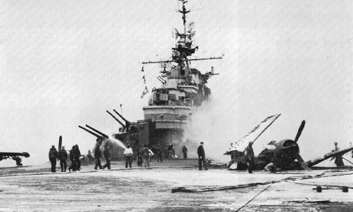 Crewmen of USS Hancock assessing the damage caused by Japanese special attack aircraft, off Okinawa, Japan, 7 Apr 1945