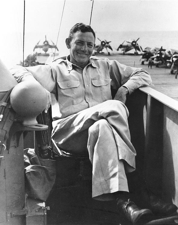 Rear Admiral Calvin T. Durgin on the bridge of his flagship, USS Makin Island, late-1944 to mid-1945; note FM-2 Wildcat and TBM Avenger aircraft on the flight deck