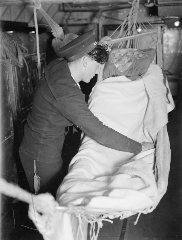 Sailor at his hammock aboard HMS Rodney, 1940