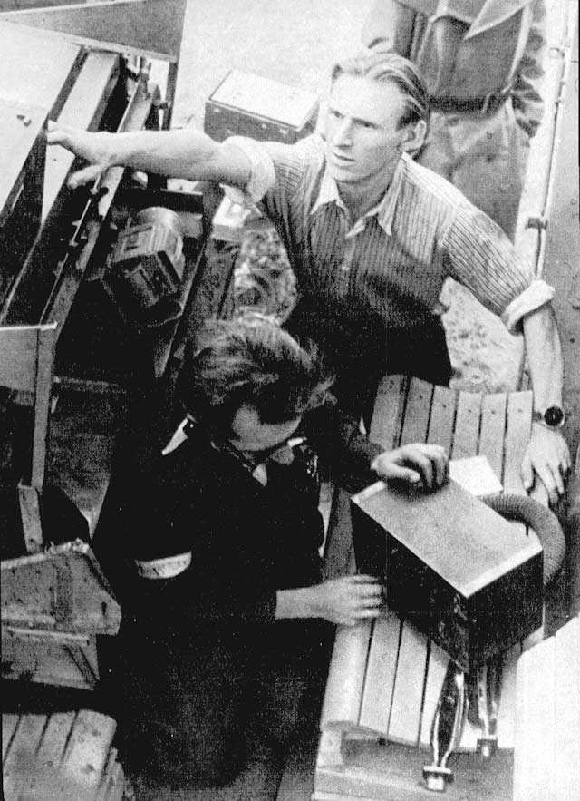 Polish resistance fighters repairing a captured SdKfz. 251 halftrack vehicle, Warsaw, Poland, 14 Aug 1944, photo 1 of 2